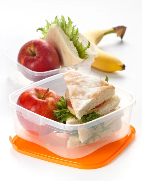 Lunch box with sandwich and apple