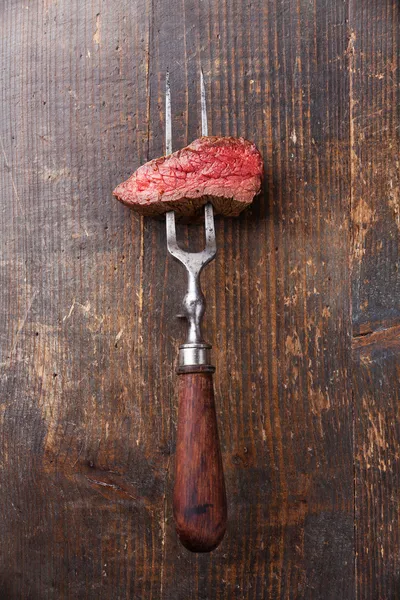 Beef steak on meat fork
