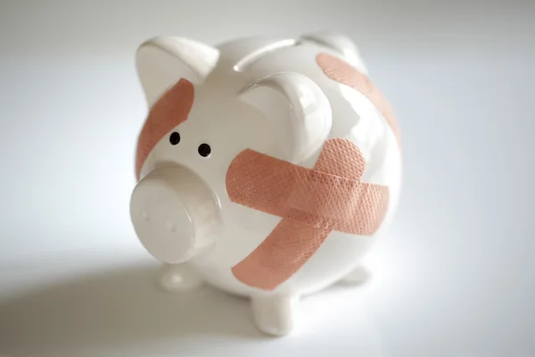 Piggy bank with band aids