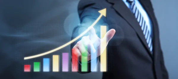 Businessman pointing to a growth chart