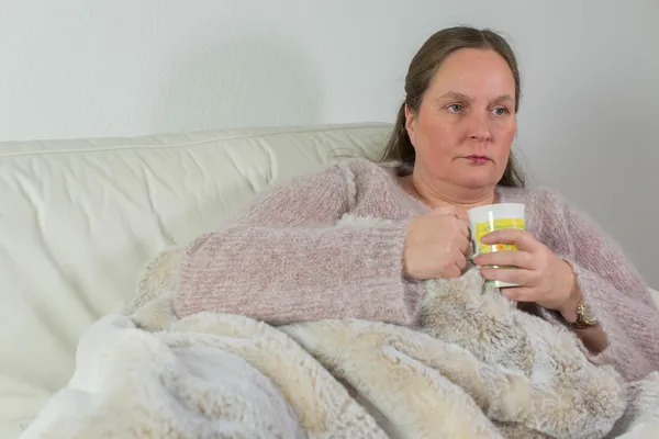 Woman has a cold and has headaches