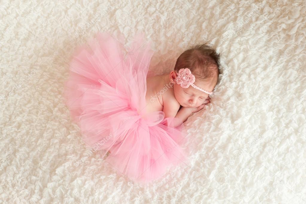 118 New baby headband tutu 477 Sleeping newborn baby girl wearing a pink crocheted headband and tutu   