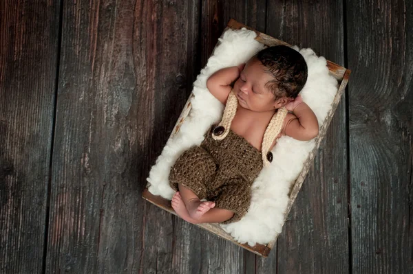 Newborn Baby Boy Sleeping in a Rustic Crate