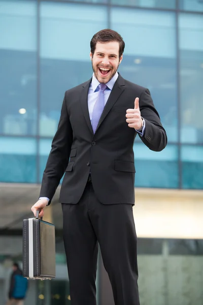 Very happy businessman showing ok sign