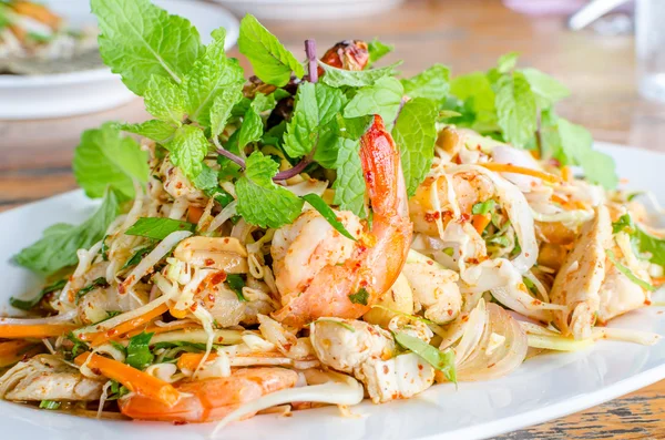 Thai Spicy salad with chicken, shrimp, fish and vegetables