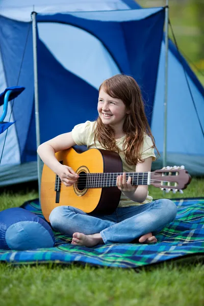 Girl Playing Guitar Against Tent