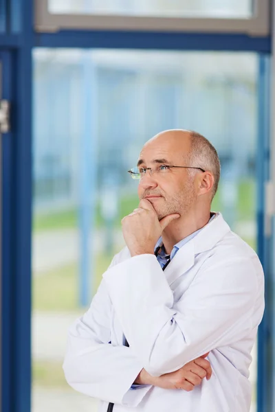 Doctor With Hand On Chin Looking Away