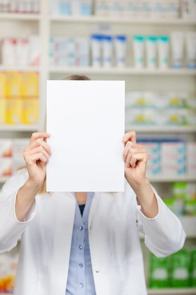 Pharmacist Holding Blank Paper In Front Of Face