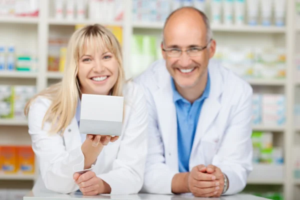 Two phamacists presenting medicin box