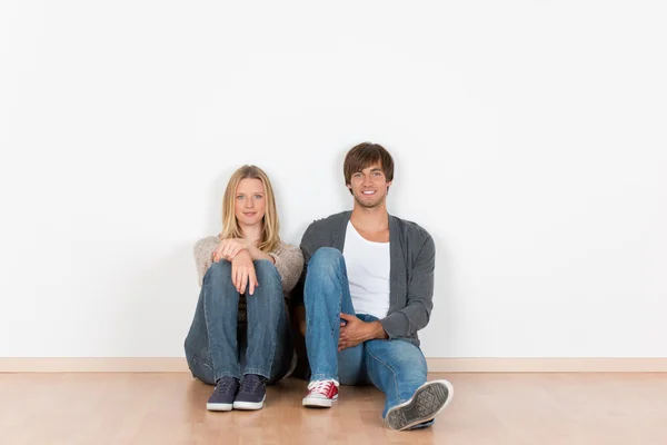 Young couple sitting on the floor