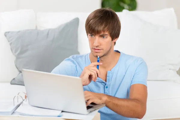 Student with laptop learning at home