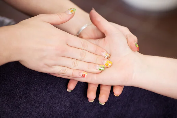 Female worker giving hand massage