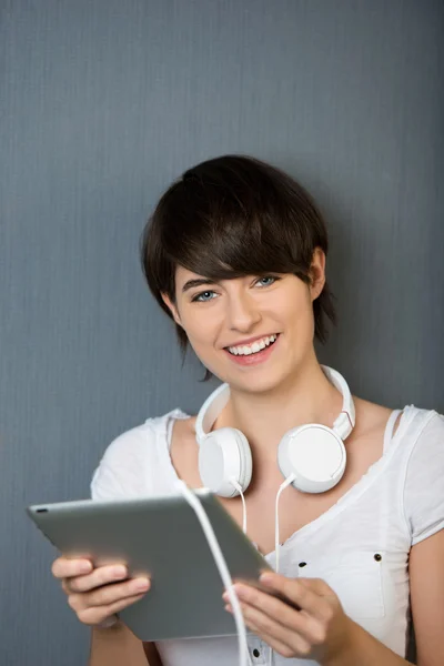 Young woman with a tablet and headphones