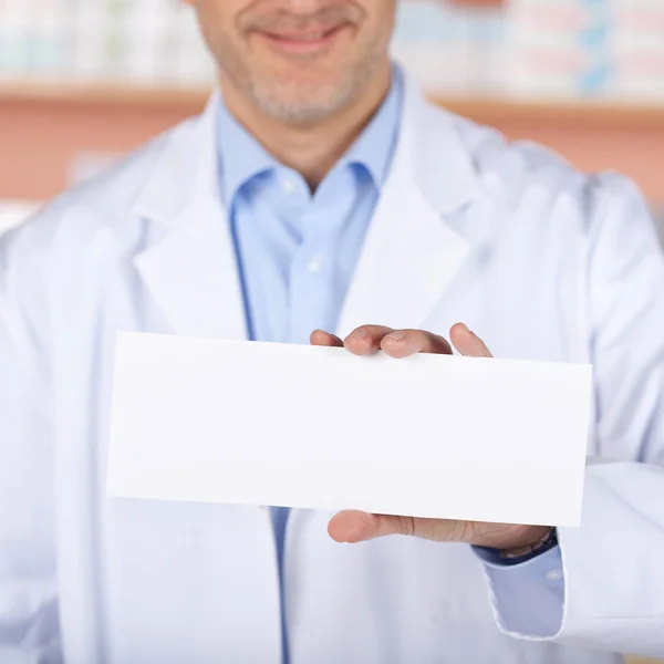 Smiling pharmacist with white paper