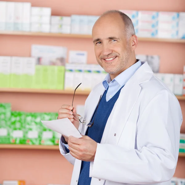 Smiling pharmacist in drugstore
