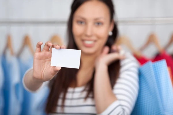 Girl Showing Blank Credit Card While Holding Shopping Bags