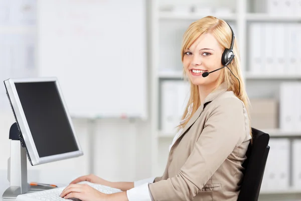 Customer Service Executive Wearing Headset While Using Computer