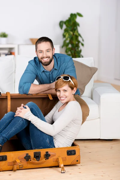 Young Couple With Briefcase In Living Room