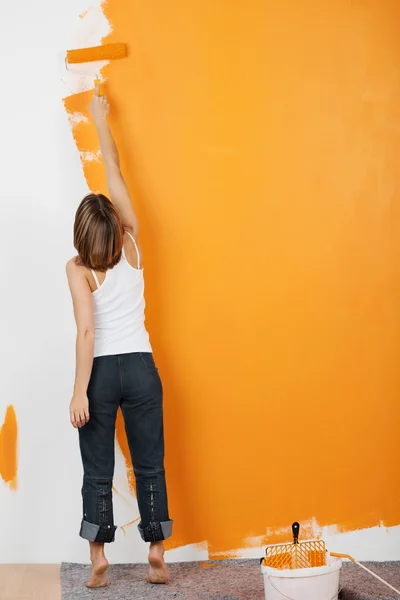 Woman paints her walls orange