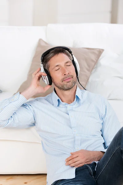 Man With Eyes Closed Enjoying Music On Headphones