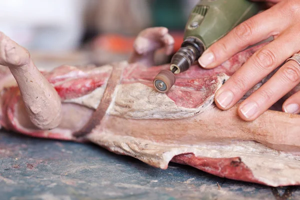 Woman's Hands Polishing Statue In Workshop