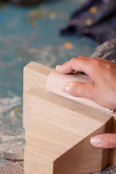 Womans Hands Polishing Wood
