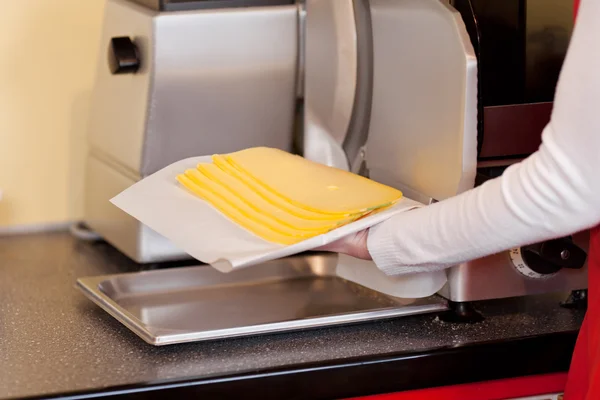 Saleslady slicing cheese