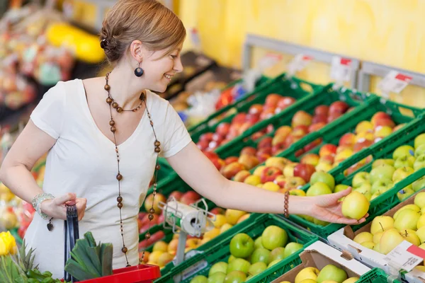 Woman Choosing Apples In Grocery Store