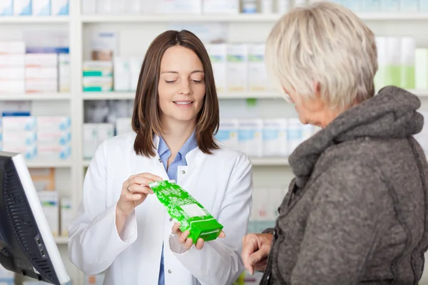 Pharmacist Explaining Product Details To Customer