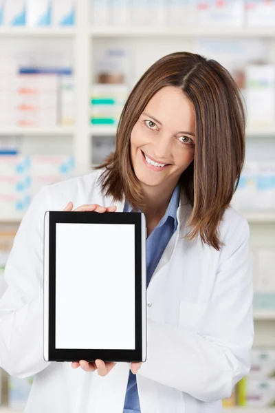 Female Pharmacist Displaying Digital Tablet In Pharmacy