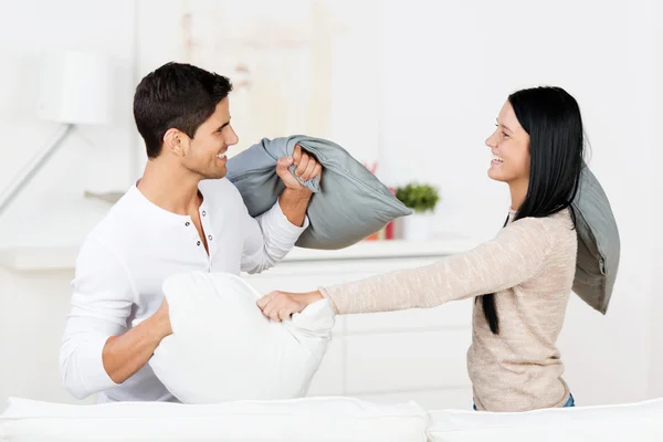 Couple Having Pillow Fight In House