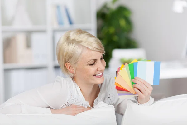 Happy Woman Holding Color Samples At Home