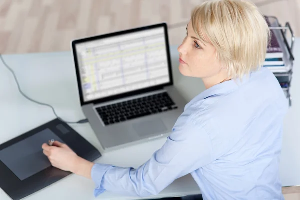 Thoughtful Female Executive With Pen