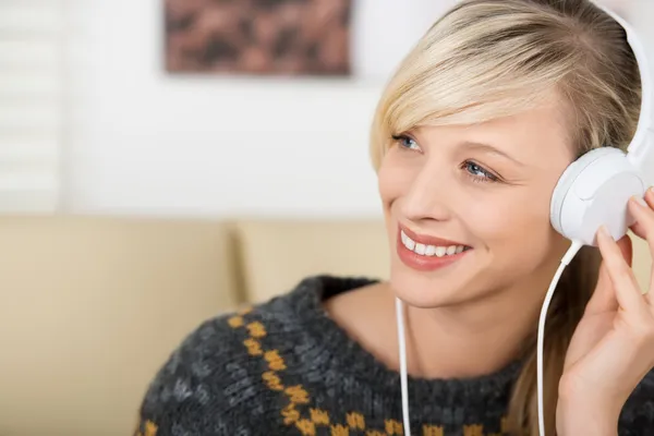 Beautiful woman listening music on headphones