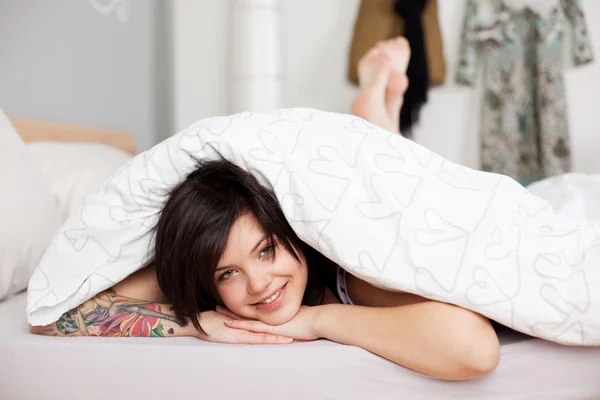 Woman Covered With Comforter Lying In Bed