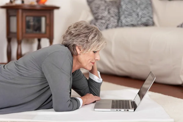 Senior Woman With Laptop In Living Room
