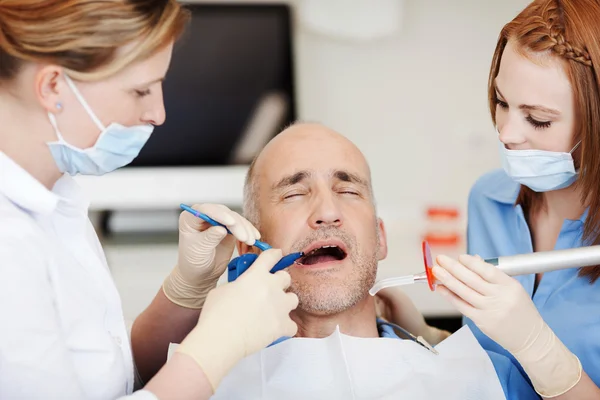 Dentists Using Dental Tools