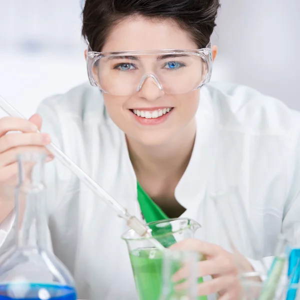 Scientist Wearing Protective Eyewear While Experimenting At Labo