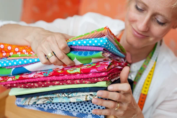 Seamstress choosing a fabric