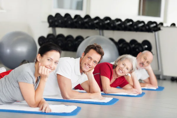 Group of people relaxing while training at the gym