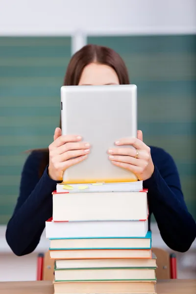 Woman with books and ipad touch