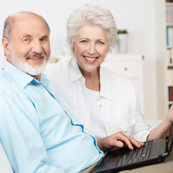Elderly couple using a laptop computer