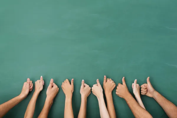 Group of people giving a thumbs up gesture