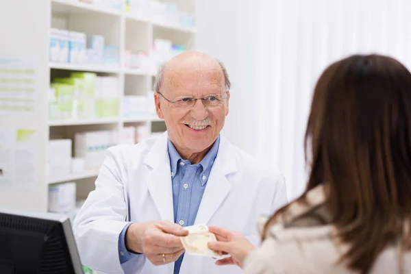 Helpful pharmacist dispensing medicine
