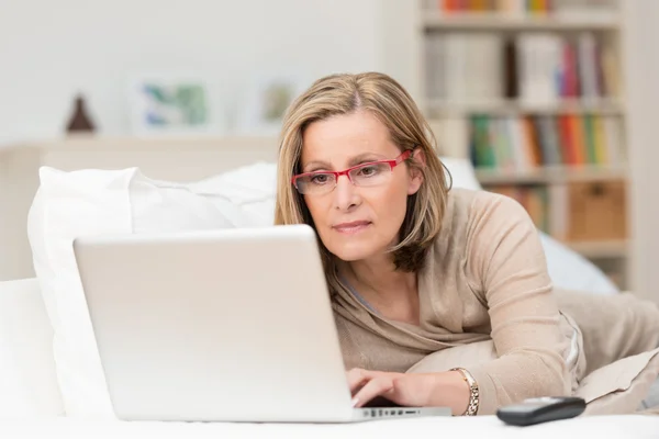 Woman concentrating as she works on a laptop