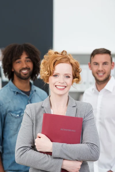 Successful female job applicant clasping her CV