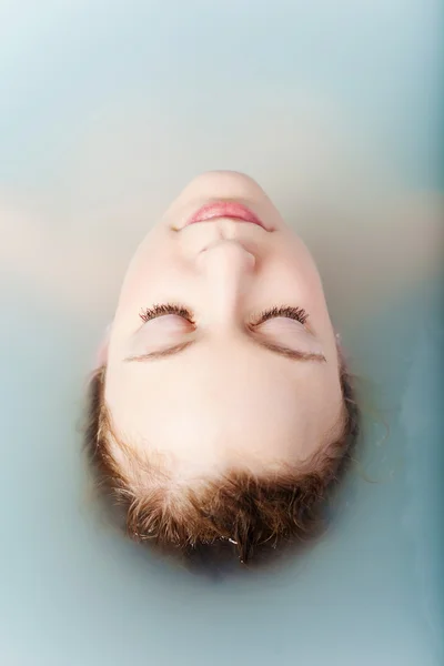 Woman soaks in the warm water