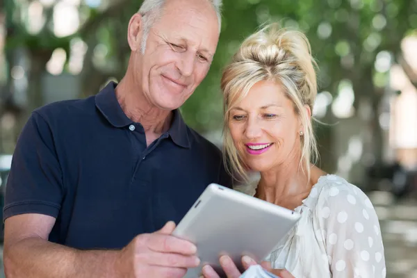 Couple reading information on tablet