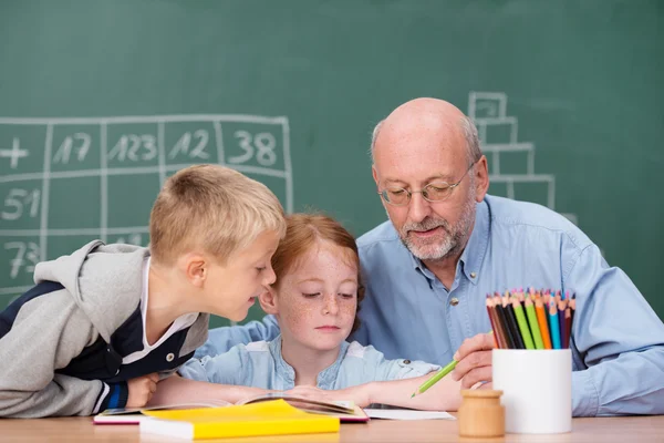 Boy and girl in class with teacher