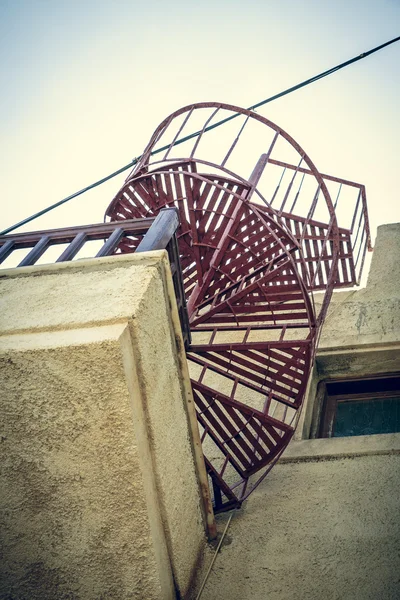 Red metal spiral stair shoot from a worm\'s eye view